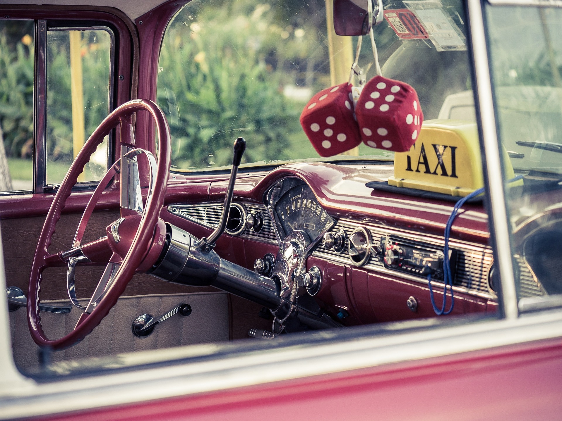 Inside of a red car with red dice in Cuba